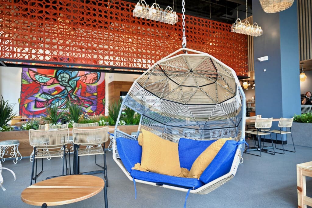 Instagram-worthy hanging wicker chairs hang from the ceiling at Ojo De Agua.  )(Photo by Alex Montoya)