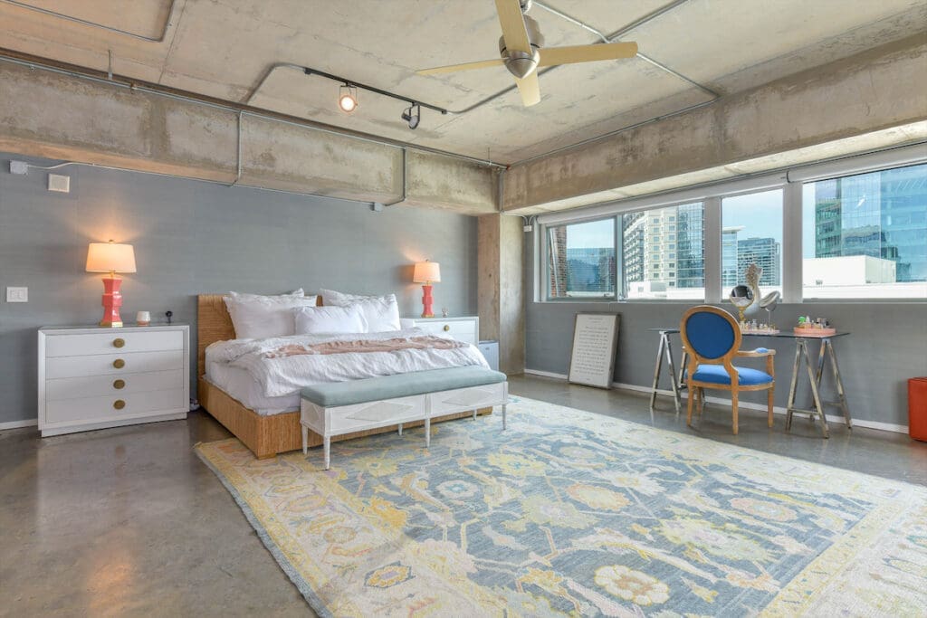 The master bedroom features Caitlin Wilson grasscloth wallpaper throughout. 