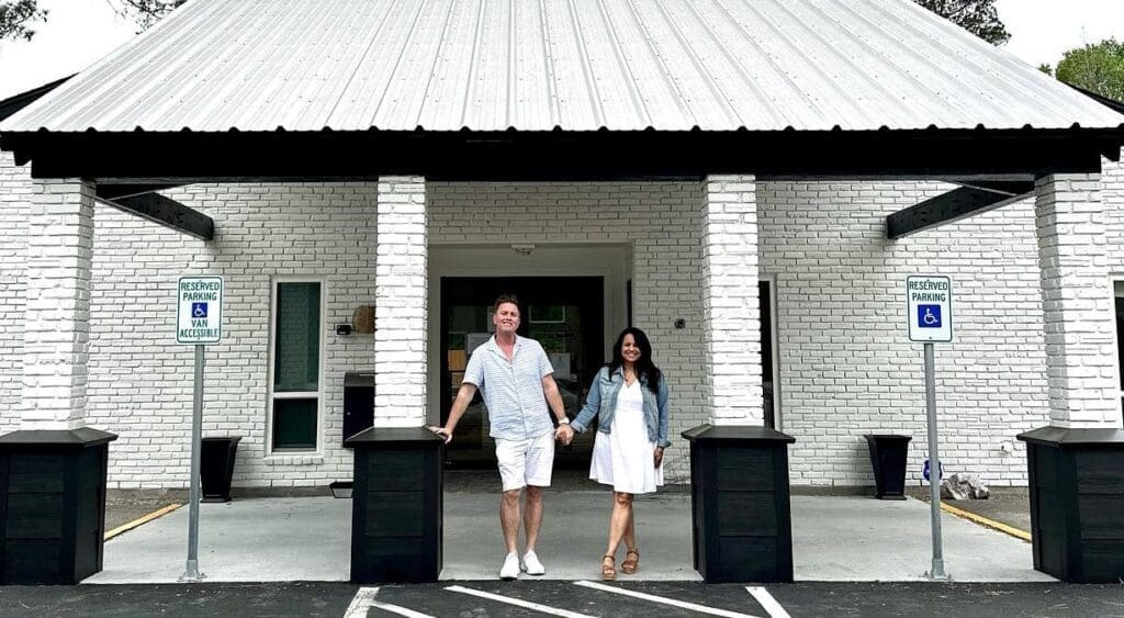 HeBrews Coffeehouse owners Geoffrey and Marsha Wood smile for a photo in front of their new location in The Woodlands. The couple already has a location in Magnolia and will be opening a location in Conroe in the near future. (Photo courtesy HeBrews Coffeehouse) 