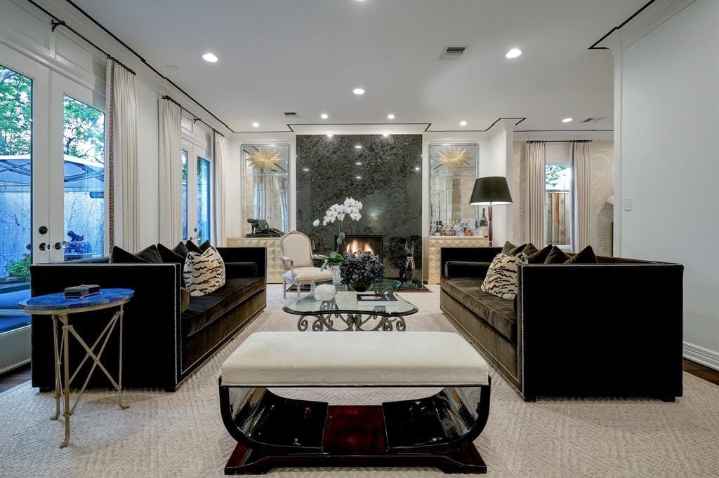 The formal living room with gas fireplace in the luxurious 'Tuscan Villa' townhome at 5722 Logan Lane (Photo by TK Images/Compass)