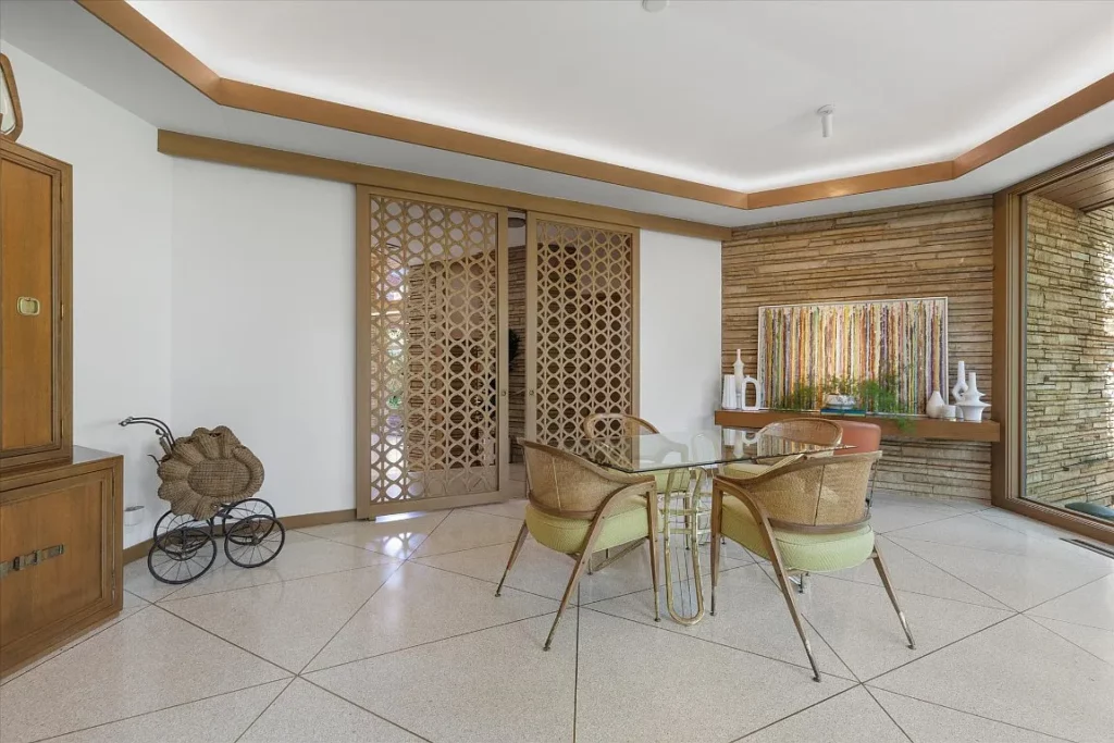 Stonework wraps inside walls with plenty of wood trim and glass walls.
