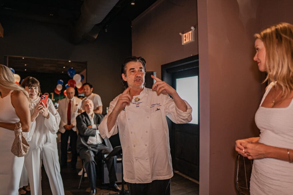Chef Philippe Schmit welcomes guests to his PS-21 Bastille Day soirée benefiting March of Dimes. (Photo by Harold Cua)