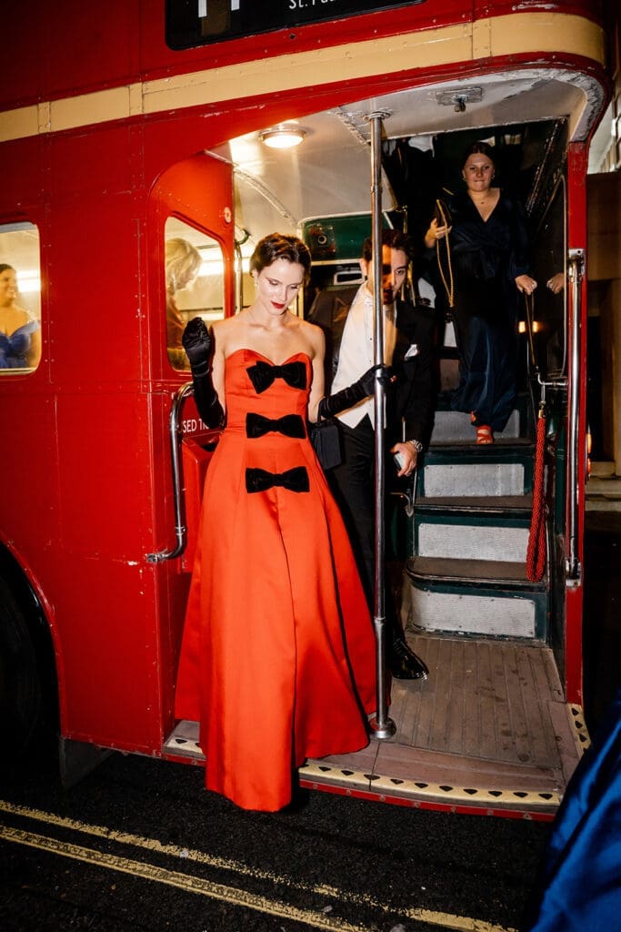  Skylar Pinchal and Oliver Coysh wedding guests departing double-decker buses for the after-party.