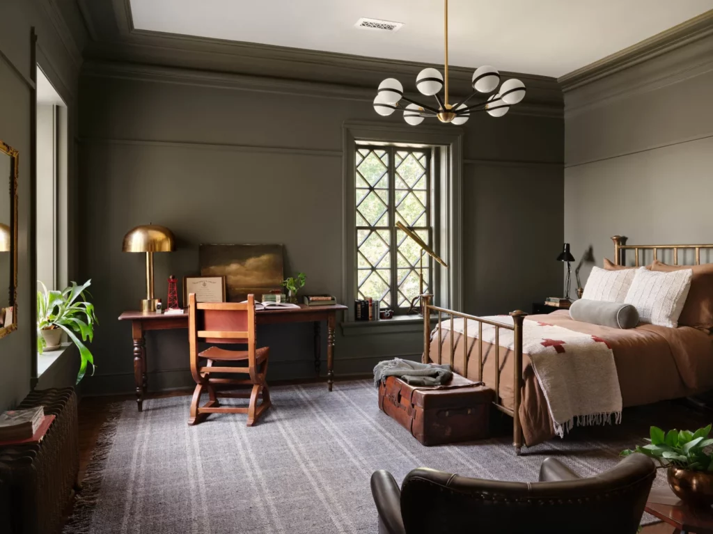 Moody olive green warms this bedroom. (Photo by Lisa Petrol)
