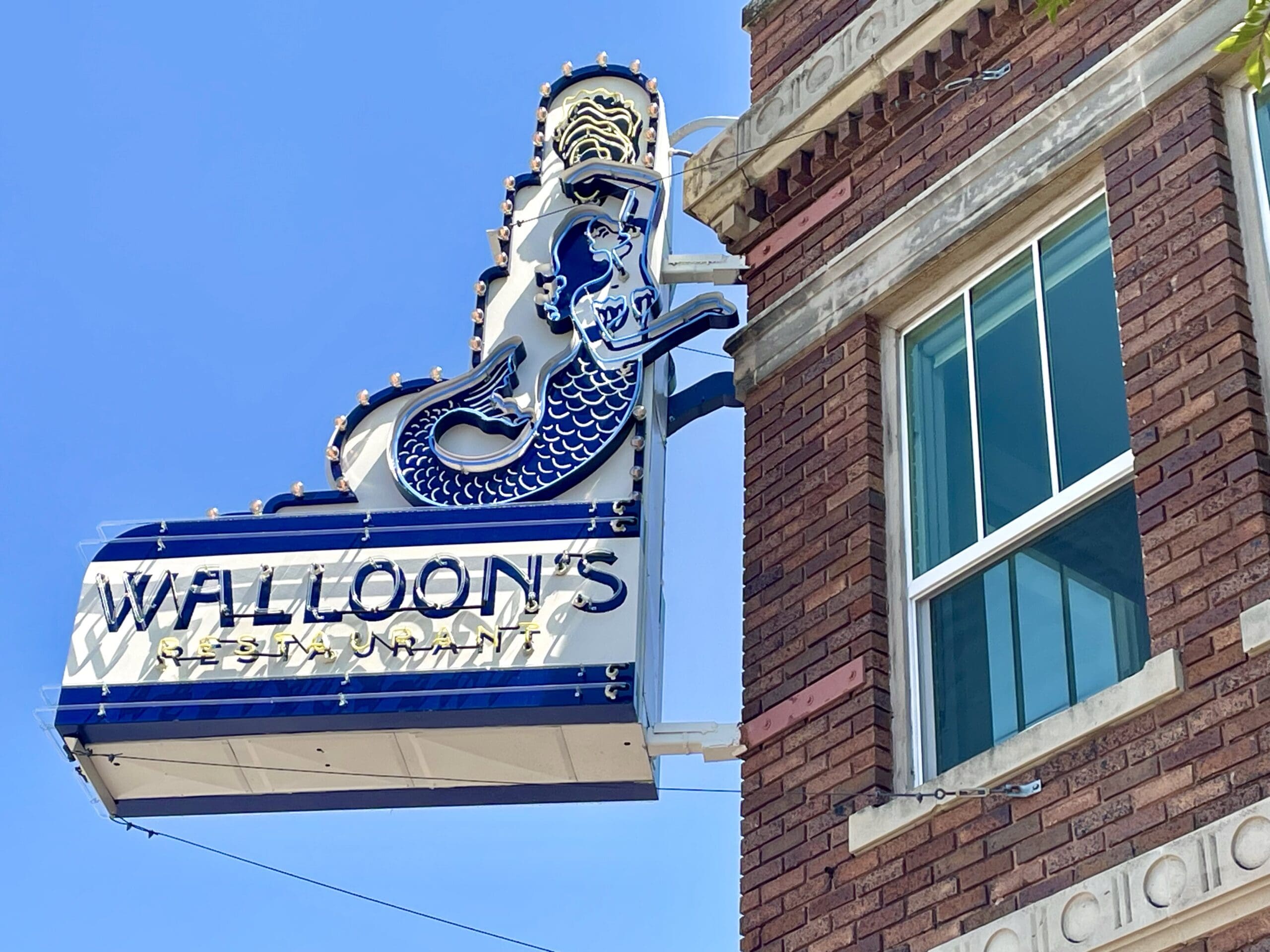Walloon's signage is installed on the historic 1927 building's façade. (Photo by Courtney Dabney)