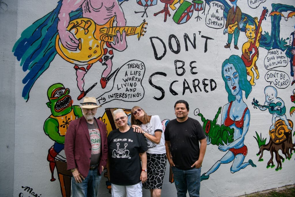 Redbud Arts Center president Gus Kopriva, executive director Tanya Peterson, Marjory Johnston, Carlos Alcaraz (Empyre) get together at the "Don't Be Scared" mural honoring the late artist Daniel Johnston. (Photo by Saranna Zhang/Kevin Zhang Photography)