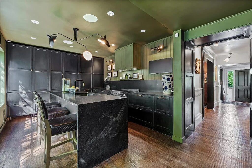 The beautifully appointed kitchen features a waterfall island and plenty of custom cabinetry. 