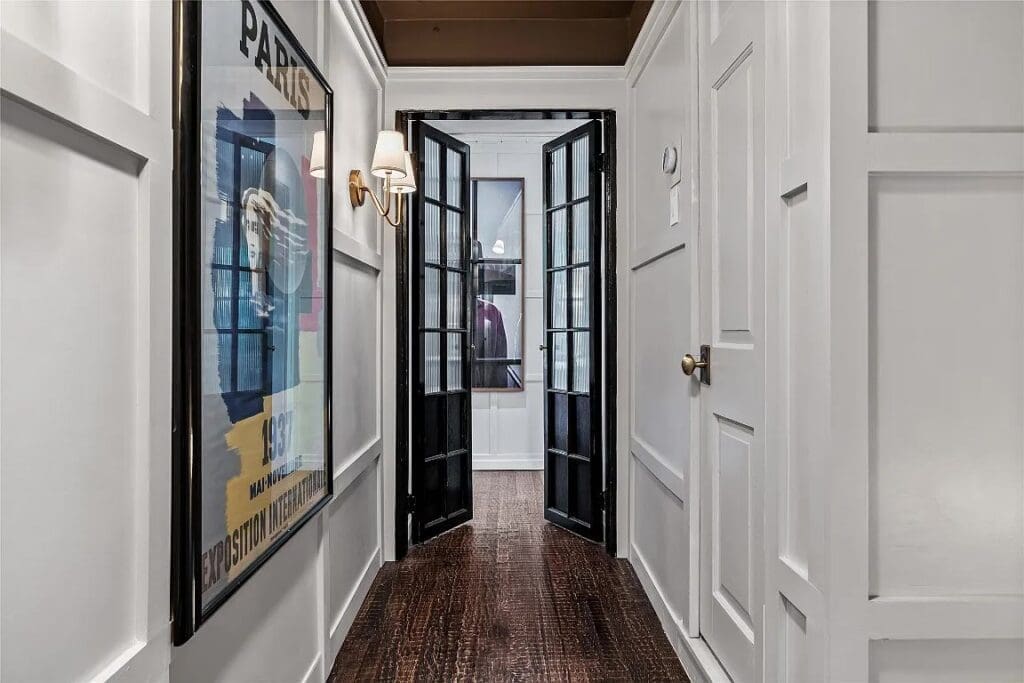 A paneled entry leads to a sophisticated upstairs hall. 