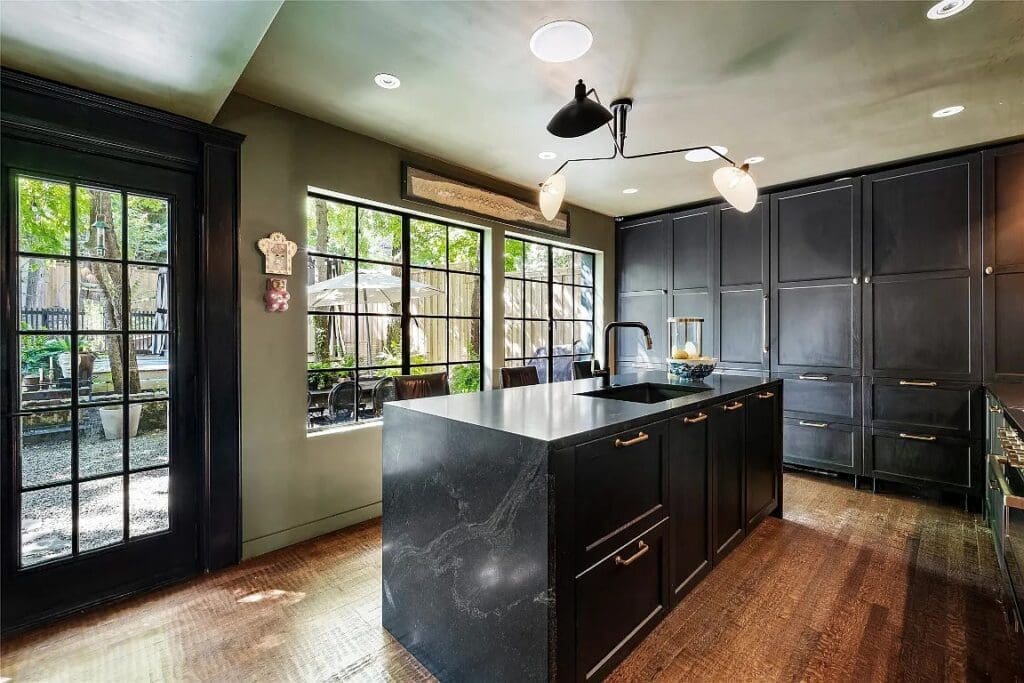 The beautifully appointed kitchen features a waterfall island and plenty of custom cabinetry. 