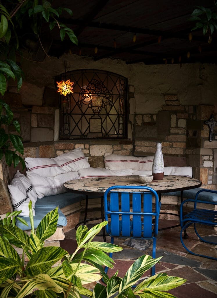 A banquette and table tucked into a grassy berm of Robert Bellamy's Old East Dallas home.  (Photo by Pär Bengtsson)
