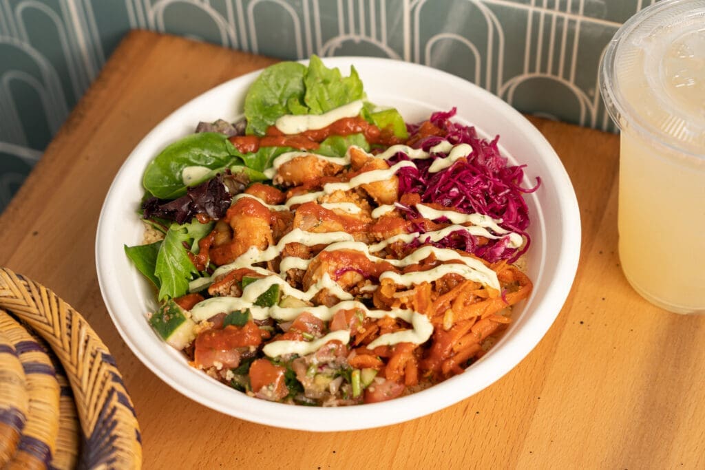 The Tangier Bowl at ZOA is built with shrimp, pickled red onion cabbage, greens, cinnamon-scented carrots, cucumber, tomato, tomato chermoula, and a zesty mint avocado yogurt sauce.  (Photo by ZOA's Shawn Chippendale)