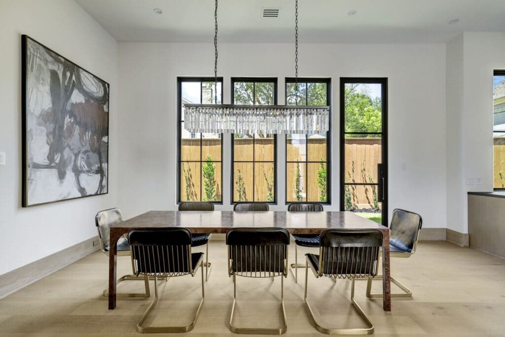 The dining room enjoys an abundance of light via the window system. (Photo by TK Images for Compass)
