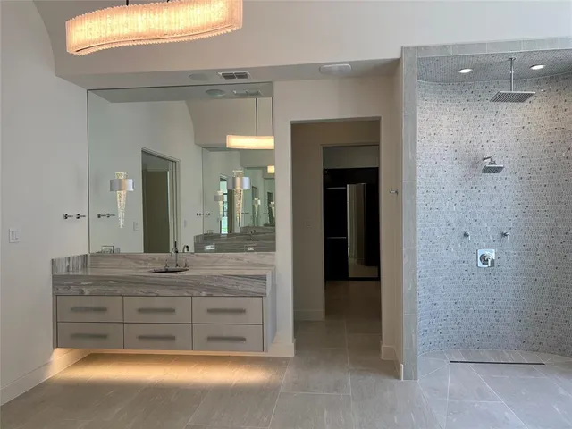 7239 Oak Valley - The expansive primary bath includes floating vanities, a soaking tup and an open rain shower.