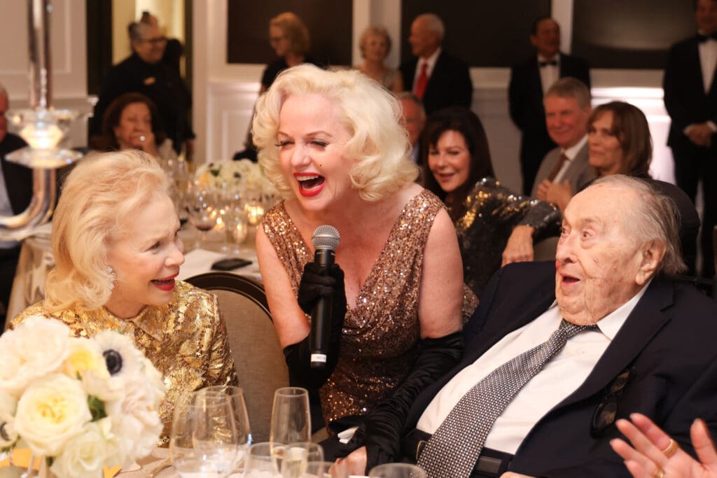 'Marilyn Monroe' entertains the honored couple at the Lynn & Oscar Wyatt birthday/wedding anniversary celebration at the Houston Petroleum Club. (Photo by Priscilla Dickson)