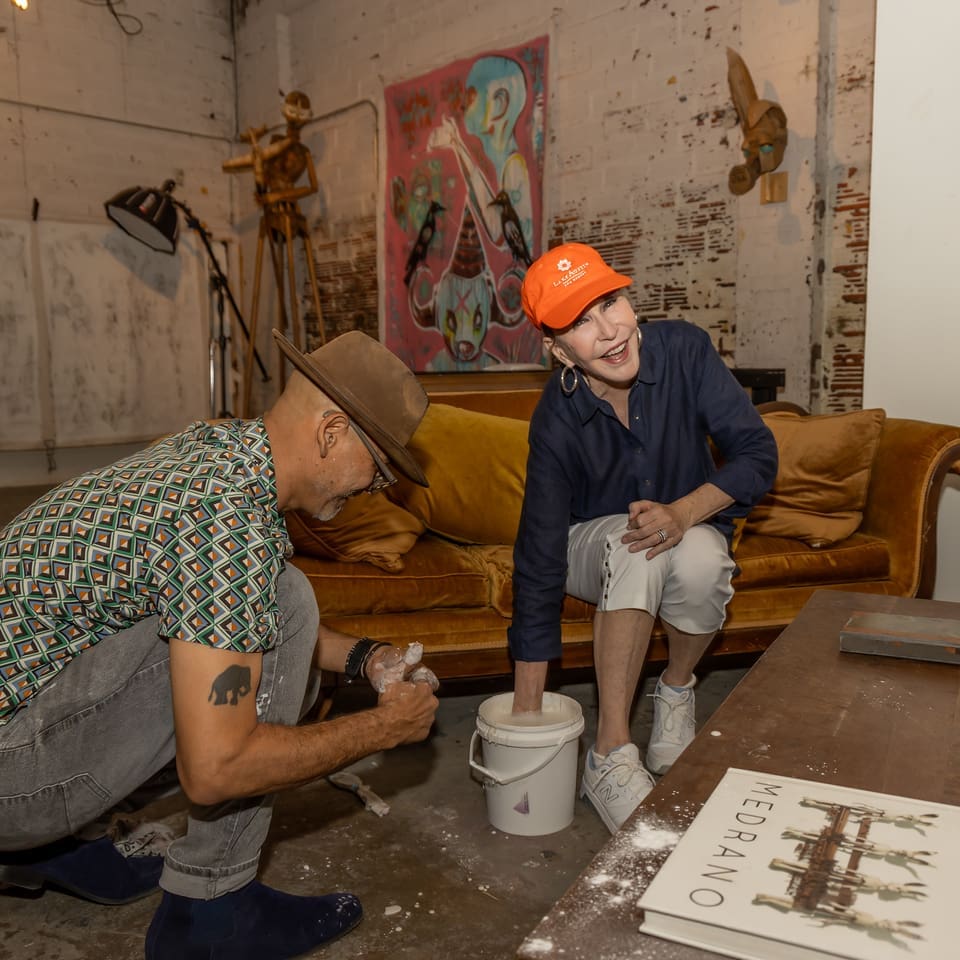 Here she goes: Shelby Hodge's hand in the bucket of goop, aka silicone rubber, for casting with Patrick Medrano. (Photo by Katy Anderson)