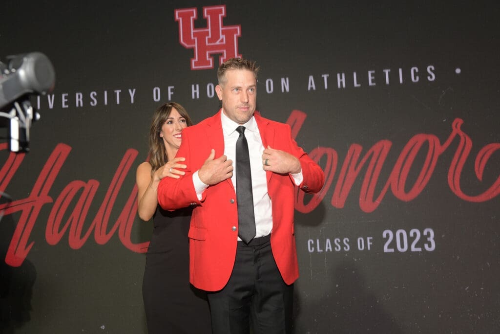 Kimberly Keenum presented her husband Case Keenum with his red UH Hall of Honor jacket. (Photo by Eddy Matchette/Courtesy UH Athletics)