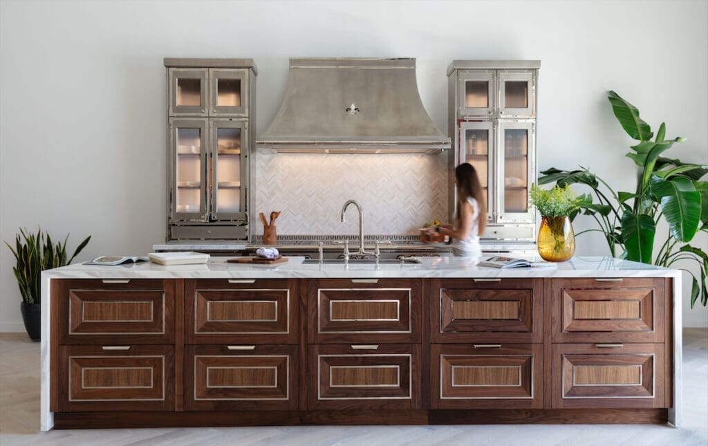 A kitchen featuring L'Atelier's new cabinetry style, Le Loire, crafted from solid American walnut.