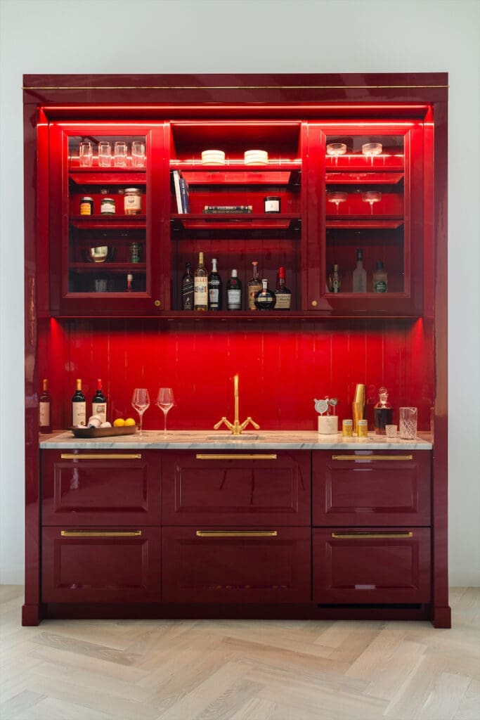 A red-lacquered wet bar features the brand’s new Bar Faucet collection.