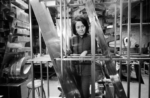 Chryssa appears in her Brooklyn studio with one of her most important neon artworks "The Gates to Times Square," 1964-1966. (Photo by Howard Harrison. Courtesy The estate of Chryssa Vardea and Tate Modern)
