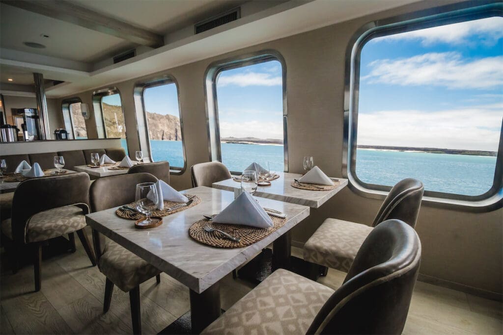 The elegant dining room features marble tabletops, with configurations for private or group dining. 