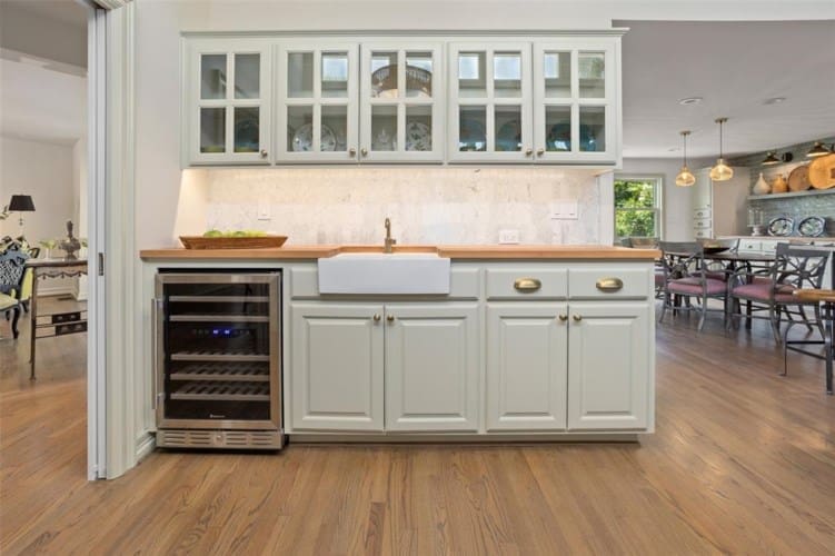 Modern butcher block topped wet bar adds to entertainers layout.