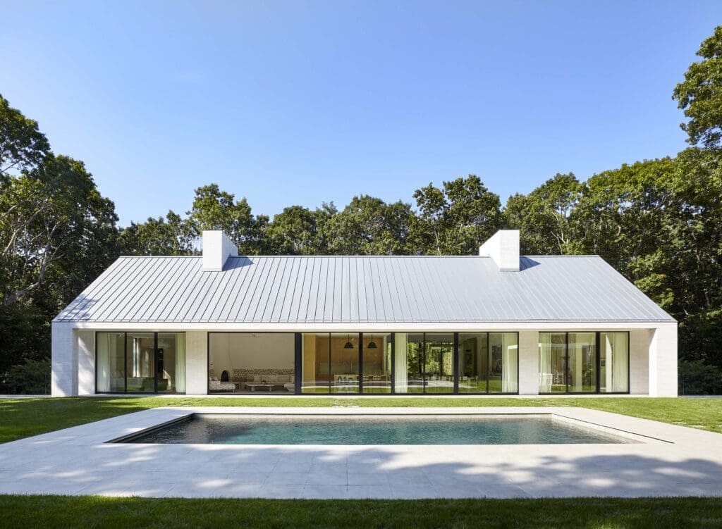 The south side of house in Southampton, designed by Sawyer | Berson, with a portico spanning its full width. The walls are handmade brick, the doors
and windows are anodized aluminum, and the roof is standing-seam zinc. (Photo by Joshua McHugh) 
