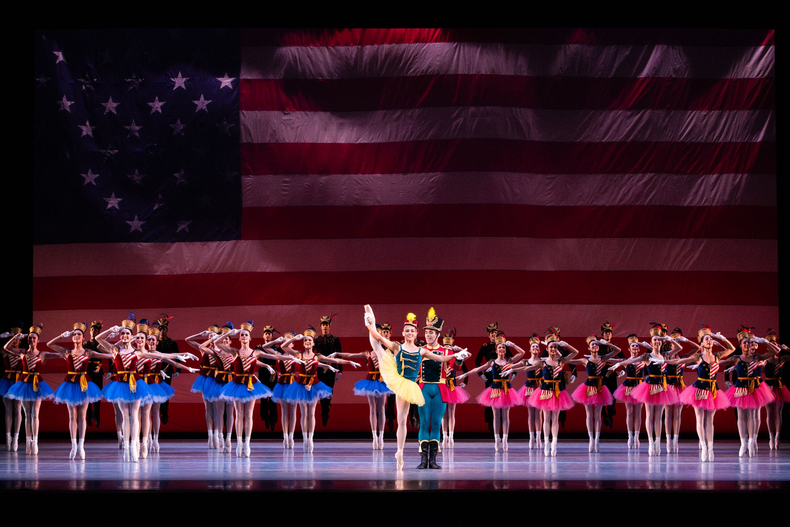 Houston Ballet first soloist Tyler Donatelli and principal Connor Walsh with artists of Houston Ballet in "Stars and Stripes." Choreography by George Balanchine, © The George Balanchine Trust. (Photo by Lawrence Elizabeth Knox. Courtesy Houston Ballet)