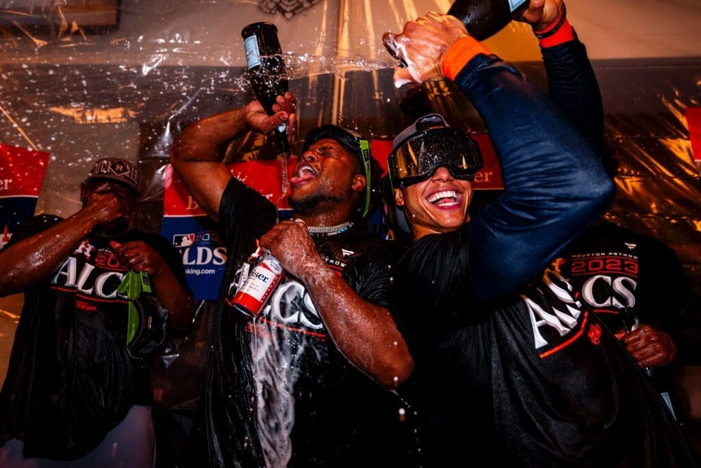 Michael Brantley Takes a Quiet Moment With Dad, Chas McCormick Goes Full Party Beast, Yordan Hides & Verlander Comes In Hot — Inside the Astros’ Epic Bottle Popping Party in Minny