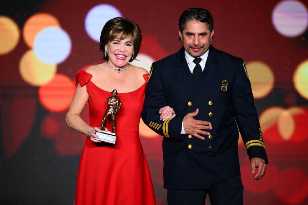 Presenting sponsor Hallie Vanderhider escorted by Fire Chief Arson Investigator Joe Trevino at the 'Red Hot Gala' benefitting the Houston Firefighters Foundation. (Photo by Michelle Watson)