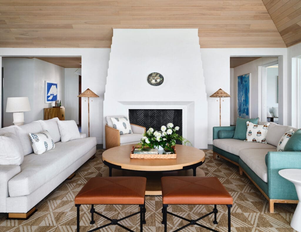 The hand-sculpted plaster fireplace was specially designed to display a Pablo Picasso ceramic fish plate. Christian Liaigre sofa at left. Philippe Hurel stools from George Cameron Nash. (Photo by Douglas Friedman)