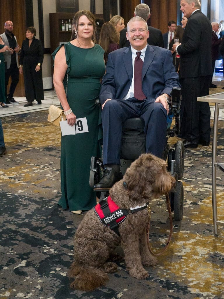 Alison Porter, Dr. Eugene Alford with Service Animal Sam at the Citizens for Animal Protection Celebrity Paws Gala (Photo by Daniel Ortiz)