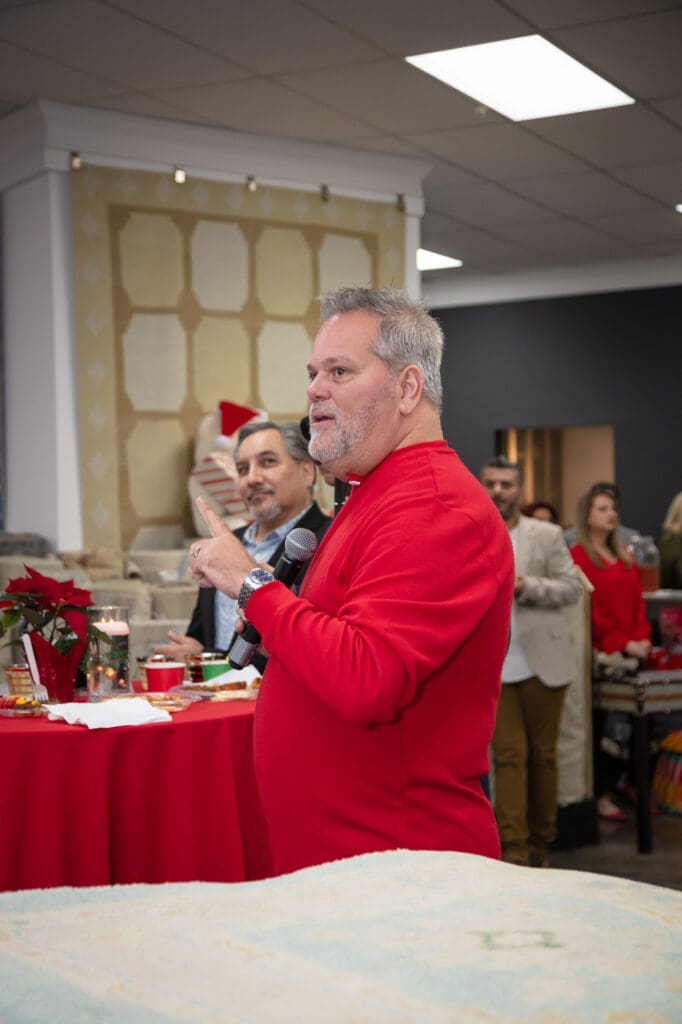 Turkish Rug Company's Mark Odom welcomes guests to the wreath design party at the new showroom in Houston Design Center.