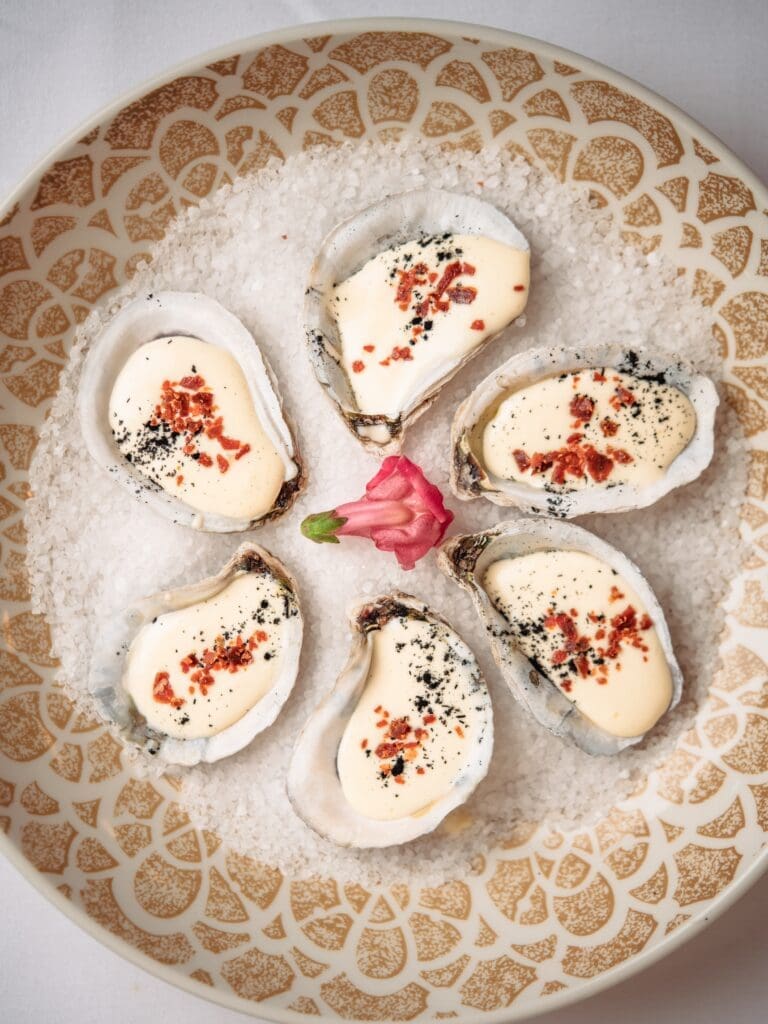 Oyster Carbonara ($24) are a Tavola feature. A half dozen oysters are topped with the rich four-ingredient sauce made with eggs, black pepper, pecorino Romano and lardons of cured pork.