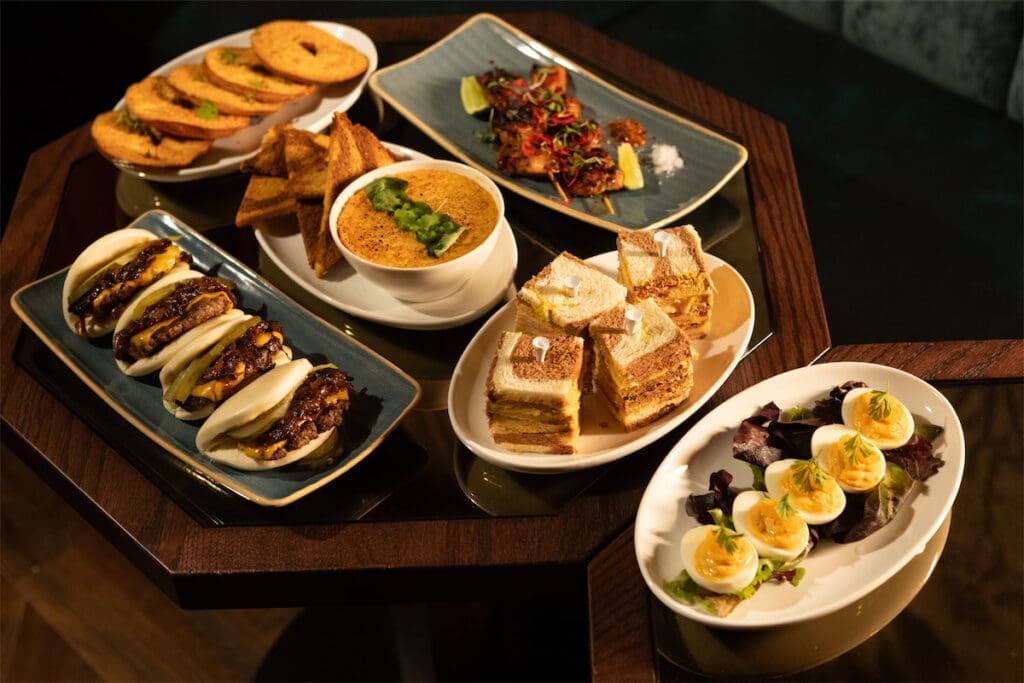 The menu at Columbian Country Club features small bites like caviar, Cobb Deviled Eggs, and Parmesan Bagels. (Courtesy of White Unicorn Agency)