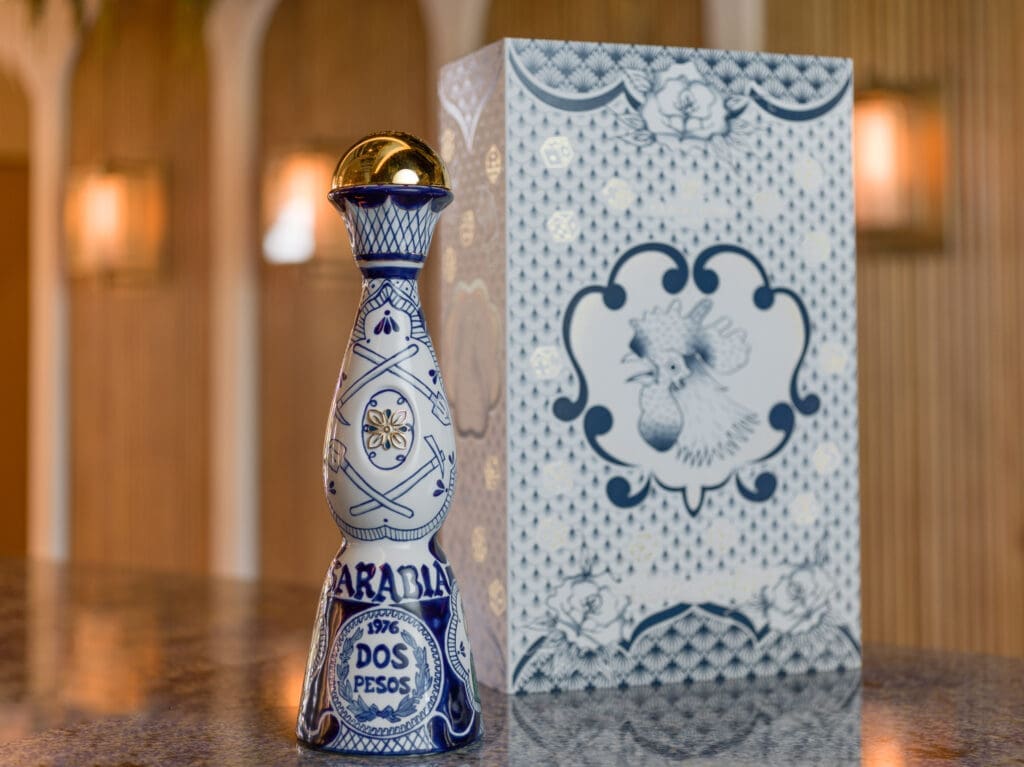 The front of the decanter depicts crossed pairs of picks and spades, as well as the face of a two-peso coin struck in the year the artist was born, both recurring elements in Sarabia’s work.