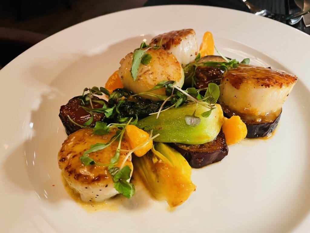Don't miss the scallops with eggplant and bok choy at Bricks and Horses. (Photo by Courtney Dabney)