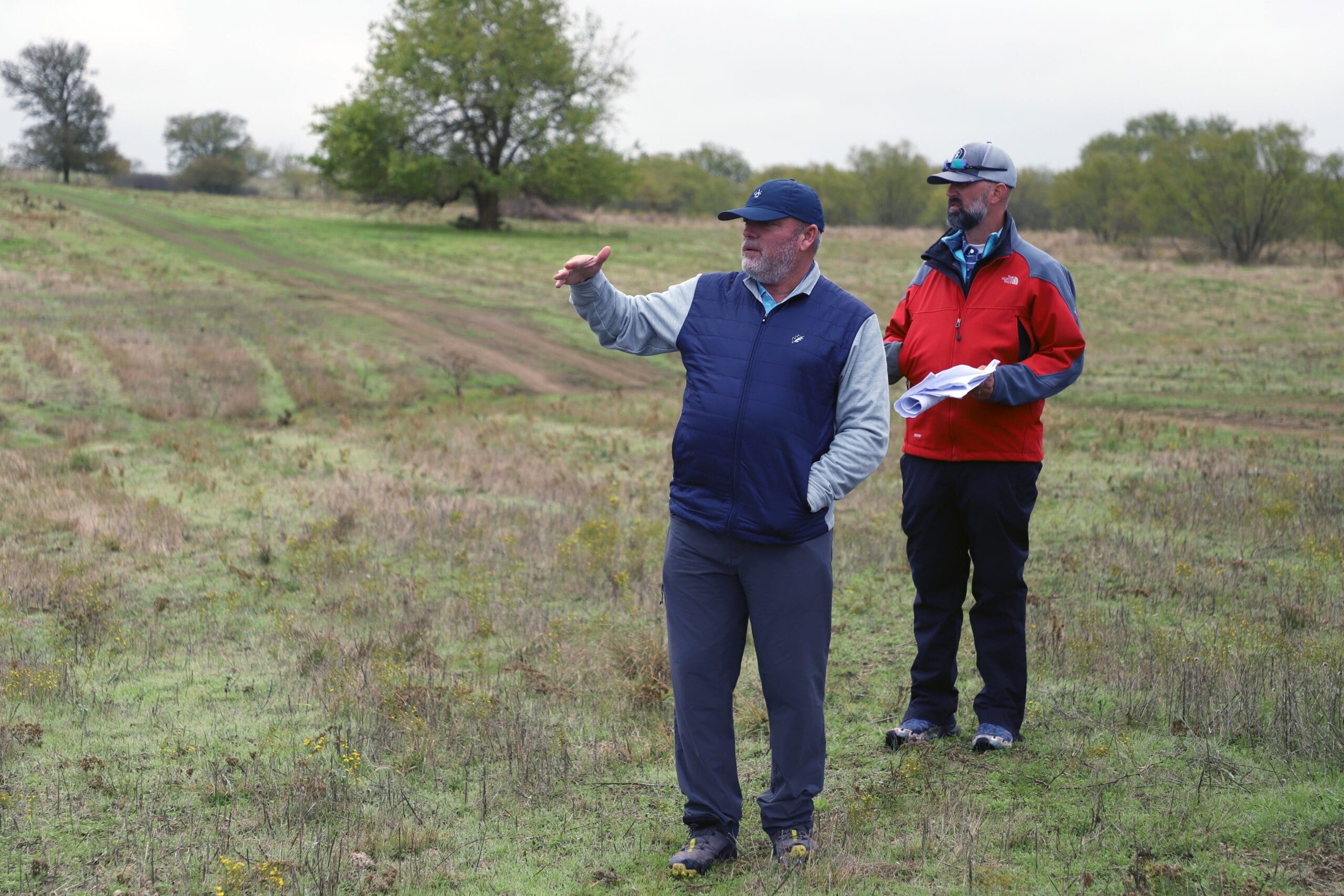Designer Tripp Davis, with Kyle Downs, exploring the terrain of hole No. 11 as Kelly Ranch Golf Course takes shape.