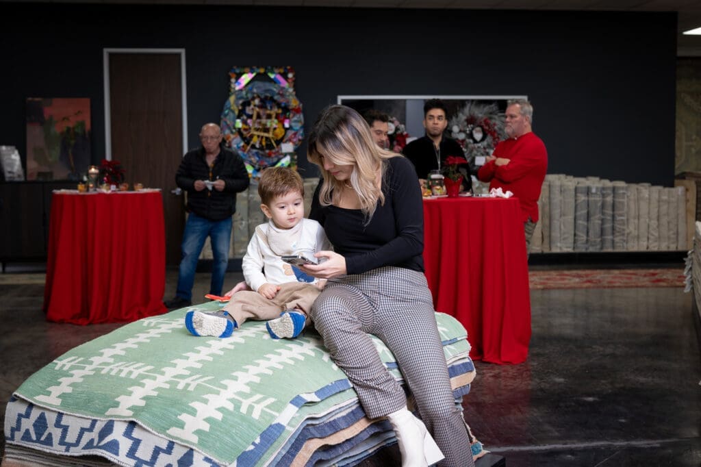 A young fan and a friend  at the Turkish Rug Company showroom grand opening party benefiting the Salvation Army.