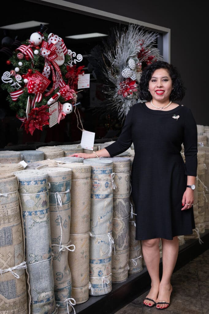 Marisol Jimenez-Aranda wins for the Most Nostalgic wreath at the Turkish Rug Company showroom grand opening party benefiting the Salvation Army.