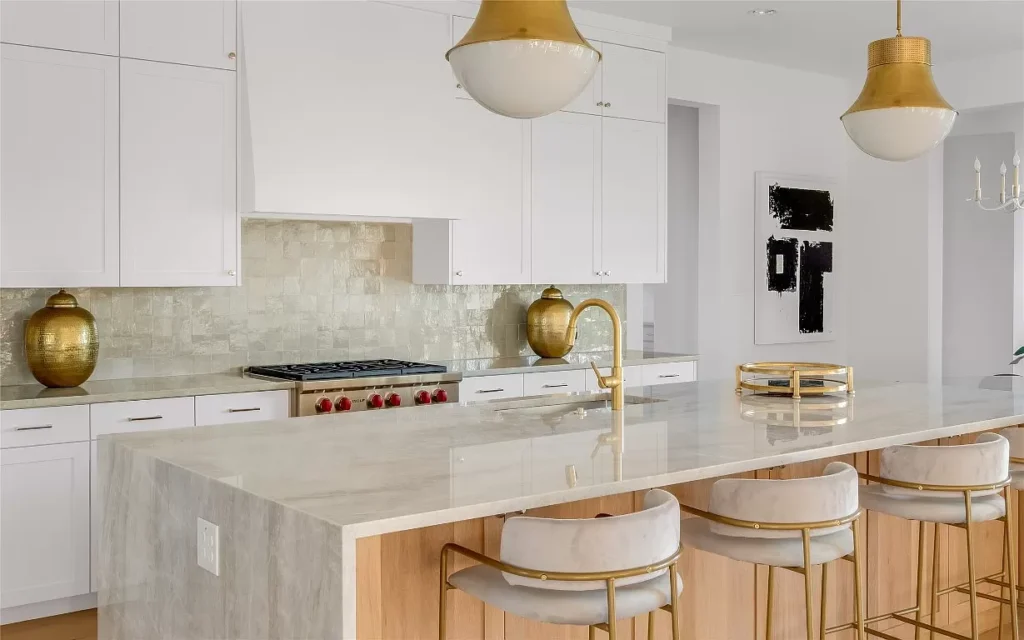 4648 Esprit Lane's kitchen features a waterfall quartz countertop on the central island and vintage-inspired pendant lights.