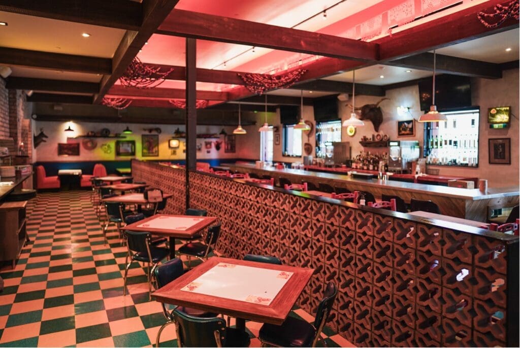 Get a look inside HiWay Cantina. The renovated space brings ample seating indoors, as well as on its outdoor patio. It features a colorful mosaic bar with vintage bar stools pulled up to its solid zinc bar top. (Photo by Morgan Weber)