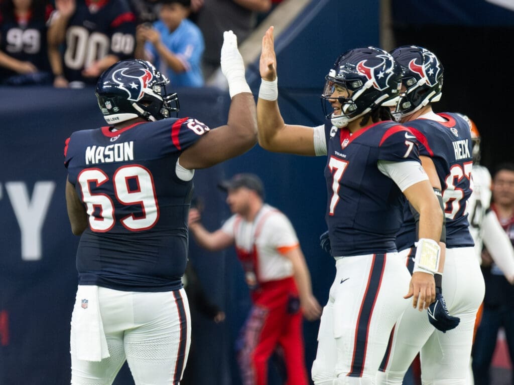 Houston Texans quarterback C.J. Stroud has a high five for everyone, including right guard Shaq Mason. (Photo by F. Carter Smith)