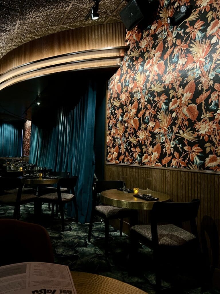 Bacari Tabu's interior features a lot of velvet, floral wallpaper, and a hidden stage for live music on weekends. (Photo by Megan Ziots)