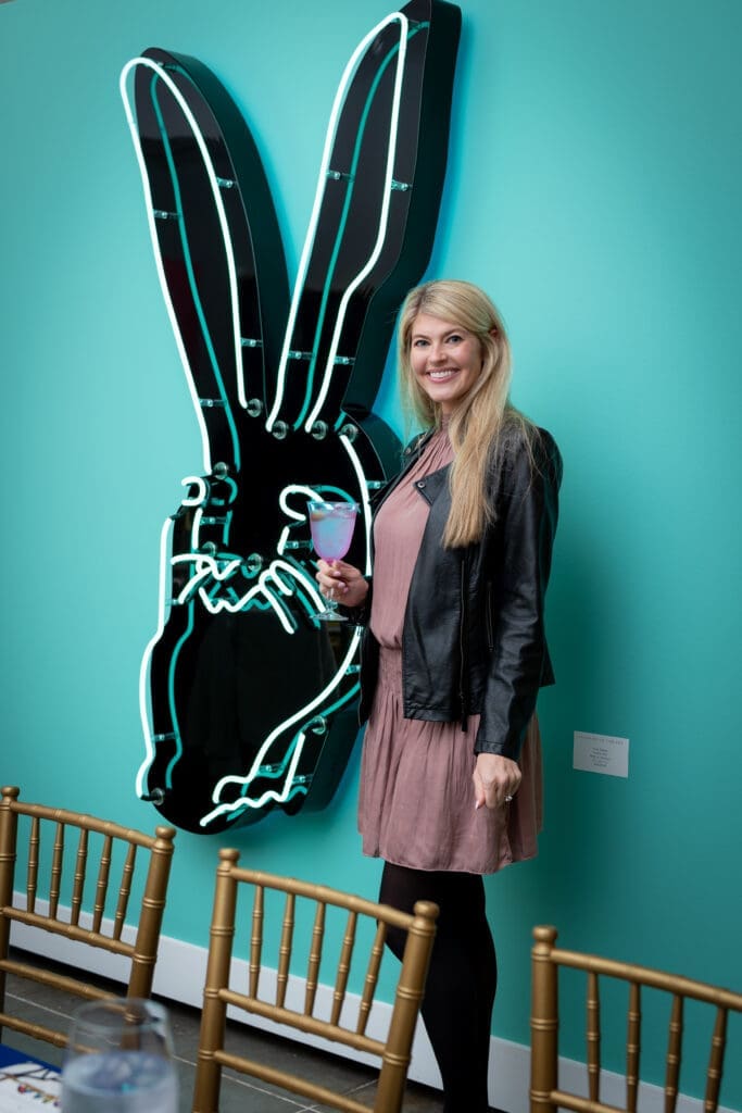 Audrey Miller admires the art at the Laura Rathe Fine Art Hunt Slonem Dinner Party (Photo by Miroma Photography)