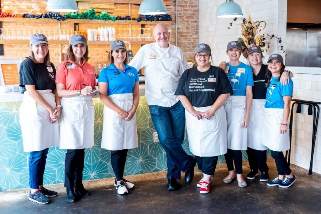 Chef Jeff Williams surrounded by volunteer staff who regularly serve at Taste Project.