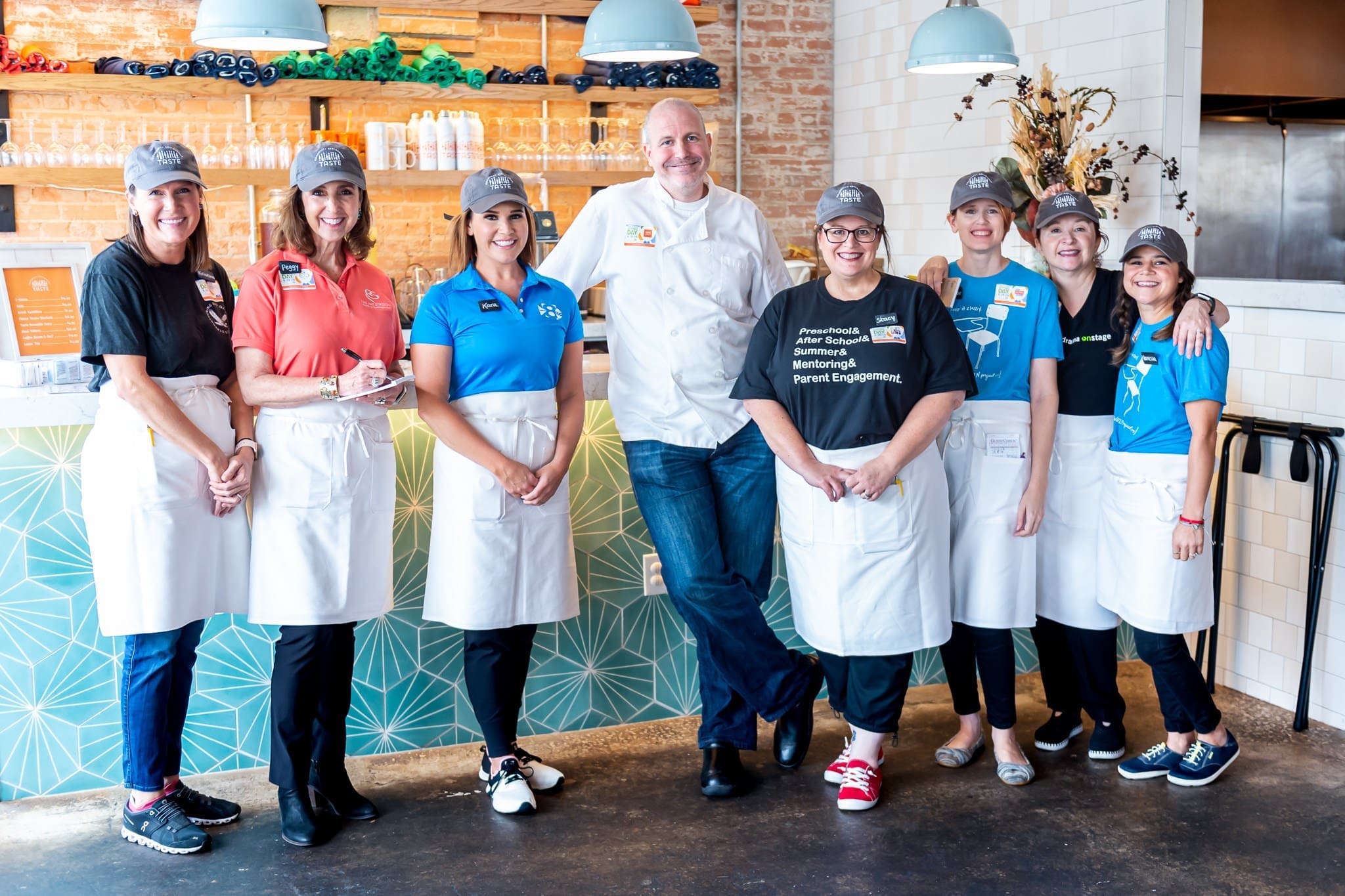 Chef Jeff Williams is surrounded by the volunteer staff who regularly serve at Fort Worh's Taste Project.