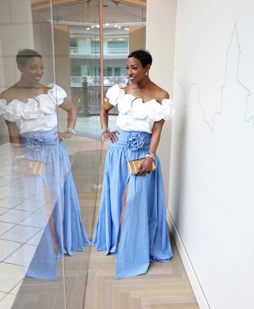 Carolina Herrera strikes again with this maxi flower skirt and floral off-the-shoulder blouse, a daring duo.