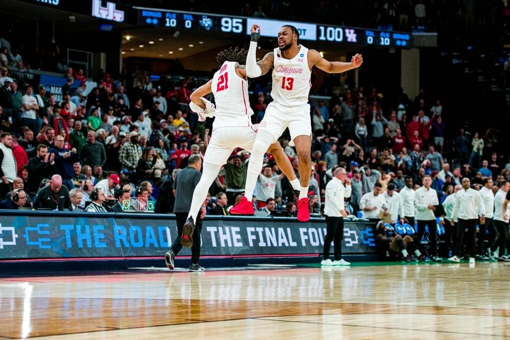 When you win an NCAA Tournament that is this epic, you'd better jump into the air like Houston players Emanuel Sharp and J'Wan Roberts do. (Photo by Matthew A. Smith, courtesy UH athletics).