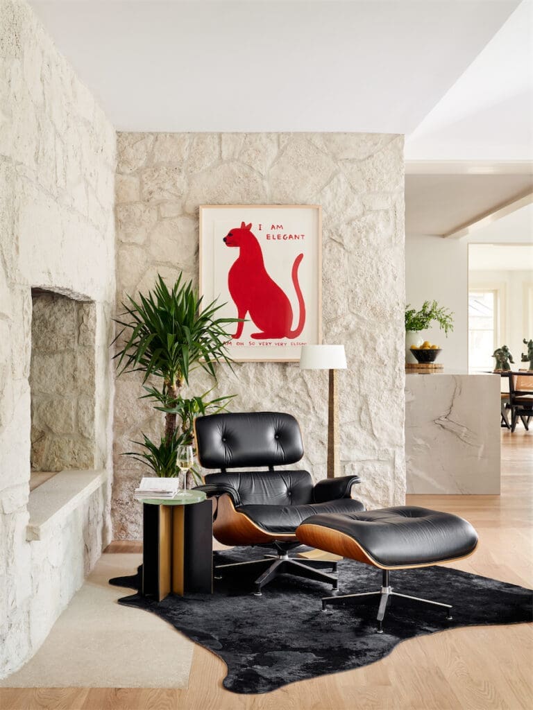 A sitting area with an original stone fireplace by Charles Dilbeck. David Shrigley vintage artwork. (Photo by Stephen Karlisch)