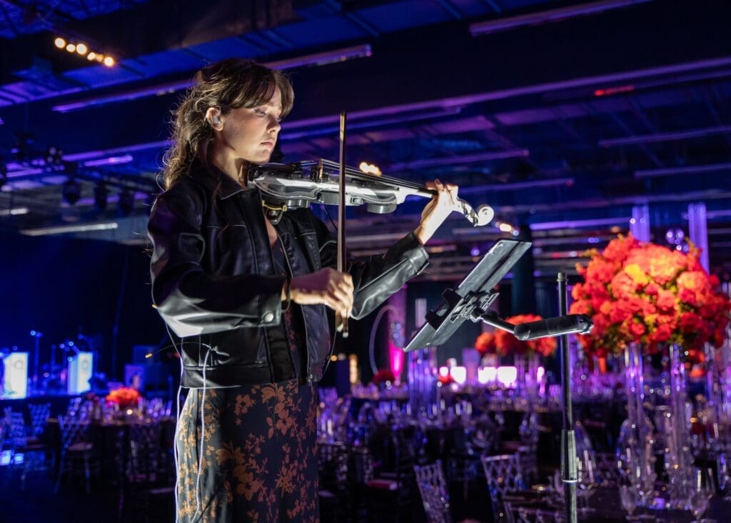 A member of electric string performers of Q The Band. (Photo by Rachel DeLira)